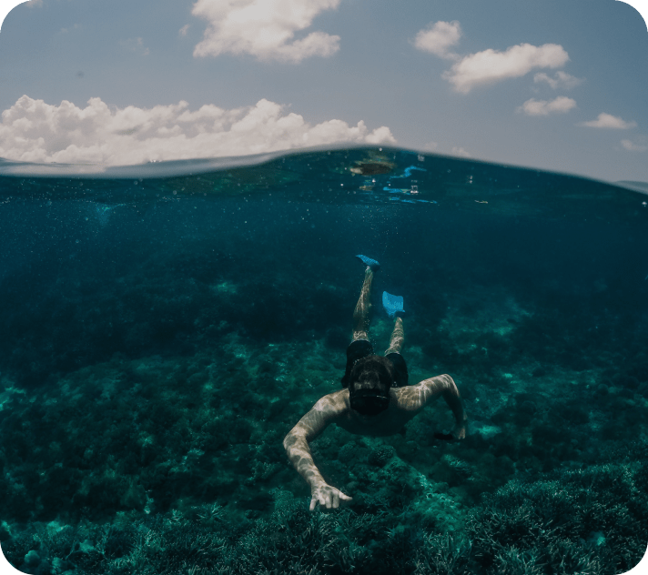 a diving man wearing diving mask under the water